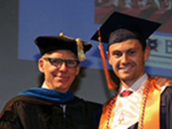 professor and student in graduation regallia