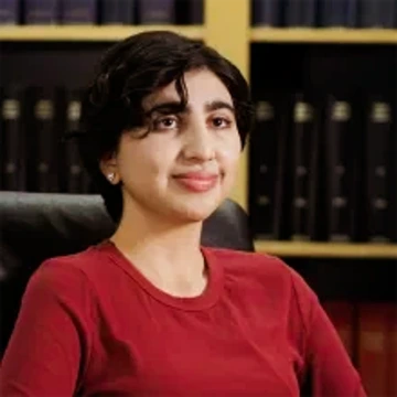 person with short dark hair, wearing red shirt