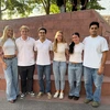 A variety of students pose for a photo together.
